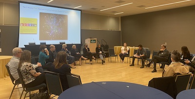 people sitting in a circle in a ballroom 